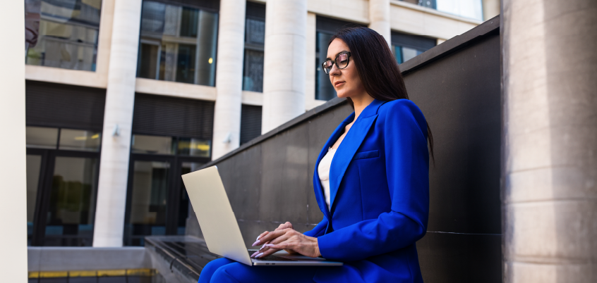 woman outside working on a laptop