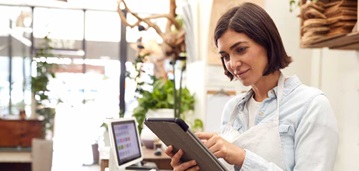 woman in retail setting using a tablet
