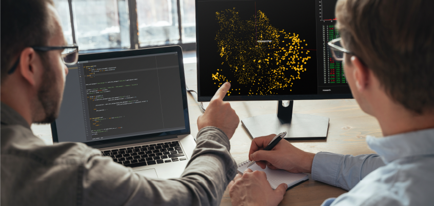 two men looking at a computer screen