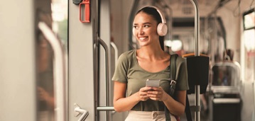 Woman with headphones on subway