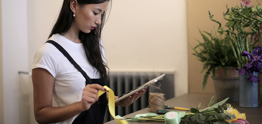 Woman working on tablet.