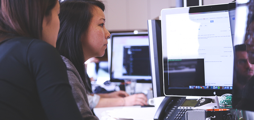 Two women looking at computer screen