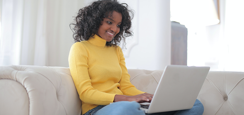 Woman working from home on laptop.