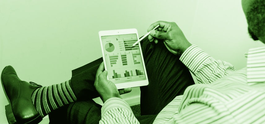 over shoulder view of man using tablet, green tint