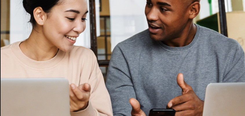 Man and woman working on laptops
