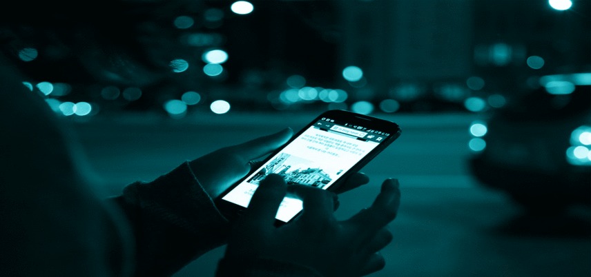 hands using a smartphone, blue tint