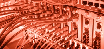 fiber-optic-copper-wireless-660x370 cables plugged into server, red tint