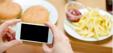 smartphone and plates of food