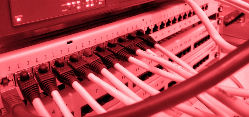 cables plugged into a server, red tint
