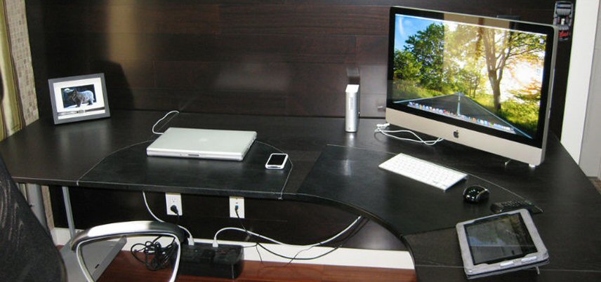 desk un an office with phone, desktop computer, and tablet