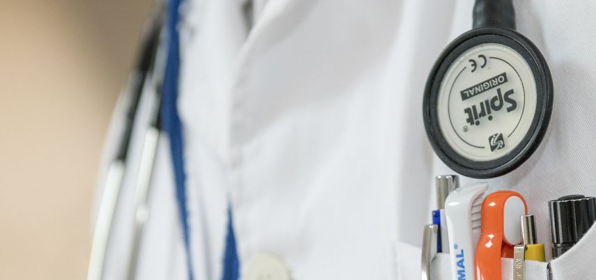 stethoscope and pocket full of pens