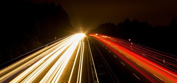 blurred image of car lights on a highway at night