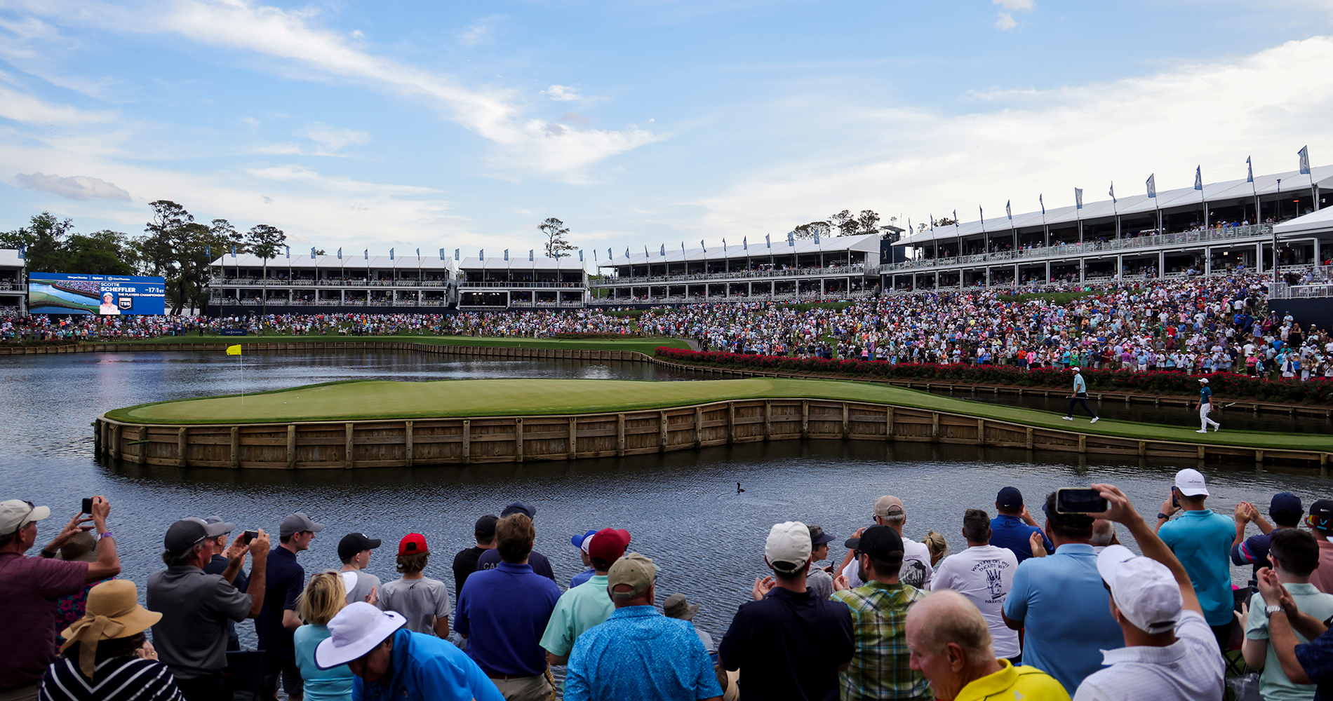 large crowd watching golfers